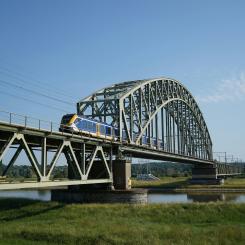 NS Sprinter-tåg på bro i Arnhem, Nederländerna Foto: Joas van der Eerden/Unsplash